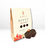 Awki Divvy 75% dark chocolate coins in 25g pouch with vibrant floral design and stacked ceremonial coins in front