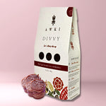 Awki Divvy white vegan chocolate coins with blackberry in a 100g pouch, featuring floral packaging and ceremonial cacao instructions
