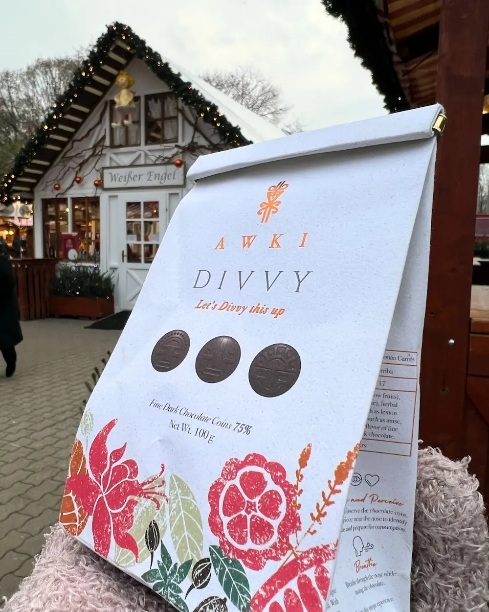 Awki Divvy dark chocolate coins displayed at a festive Christmas market in Germany