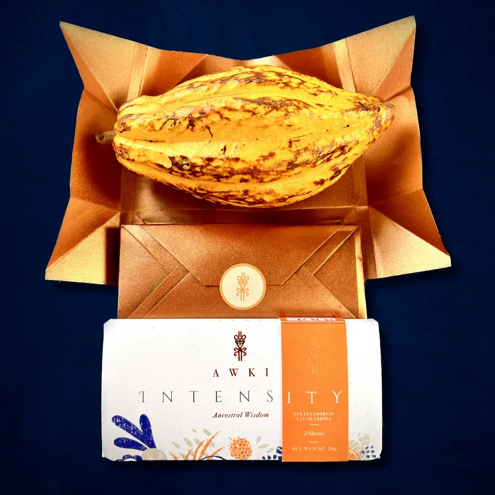 AWKI Intensity chocolate bar with golden cacao fruit on copper gift envelope, showcasing premium Ecuadorian cacao presentation.
