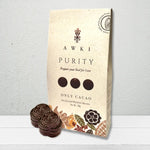 Awki Purity 50g cacao pack with cacao coins displayed on light wood surface