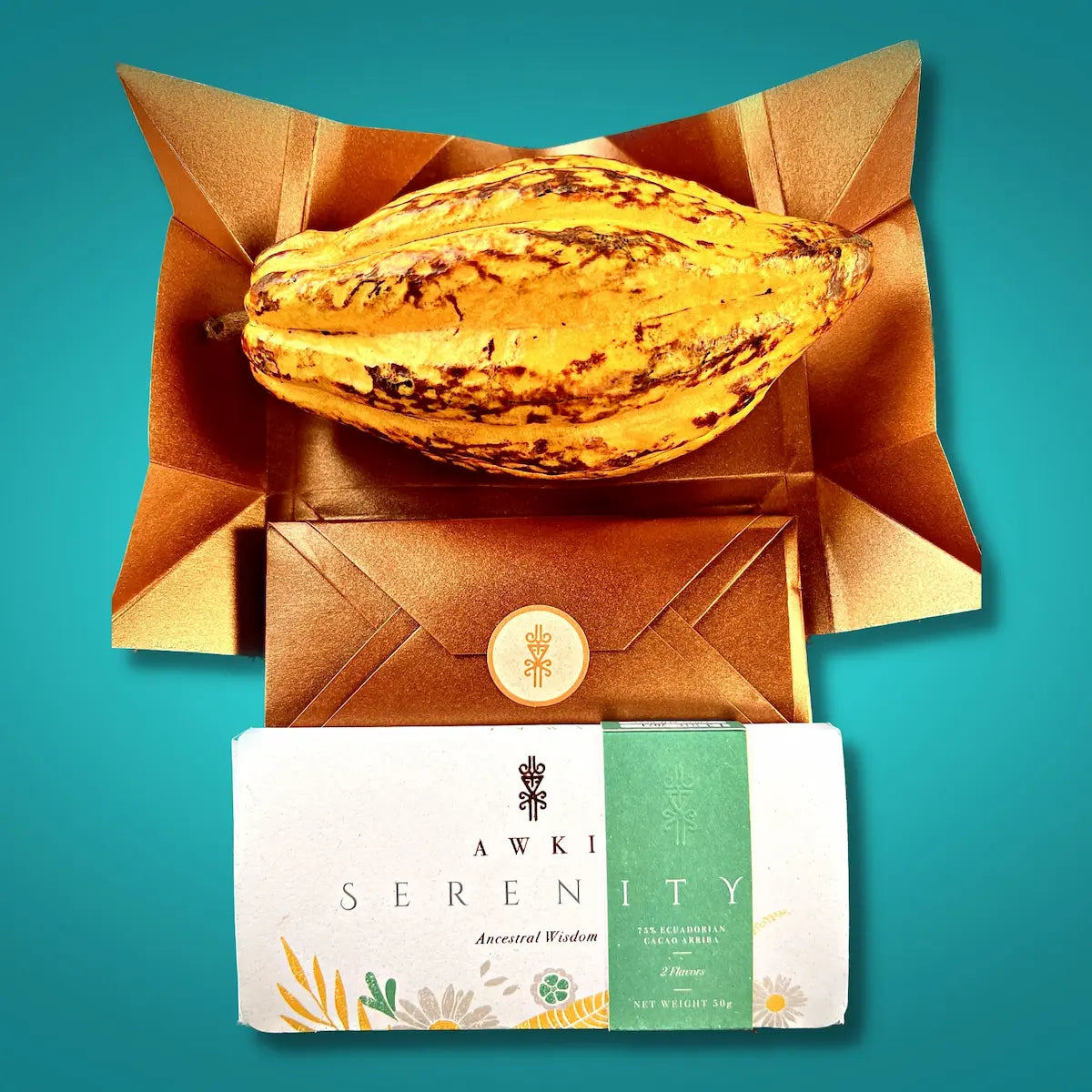 Awki SERENITY chocolate bar shown with cacao fruit and signature golden envelope packaging